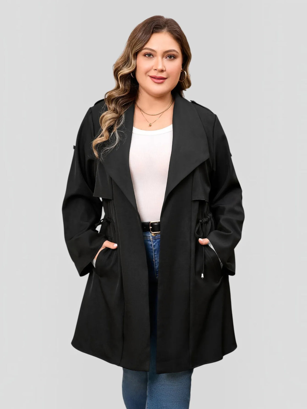 Drawstring-waist trench coat in black, front view with hands in the pockets.