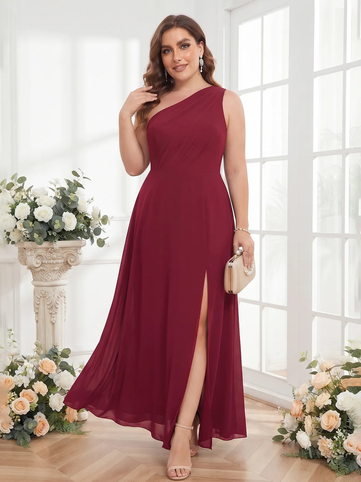One-shoulder chiffon maxi dress in burgundy, styled beside a floral display.
