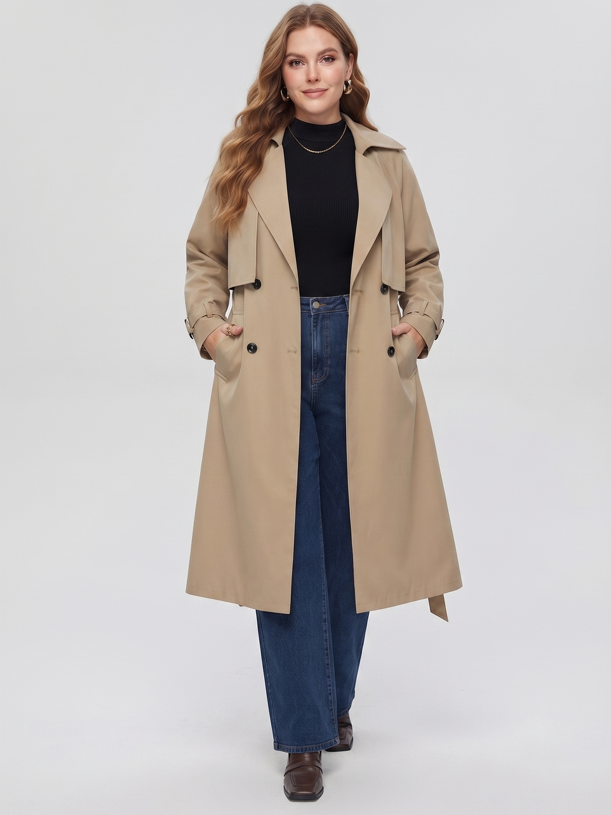 Belted midi trench coat in beige, front view with hands in the pockets.
