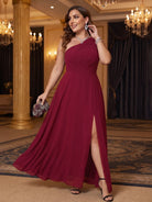 One-shoulder chiffon maxi dress in burgundy, evening outfit with a clutch.